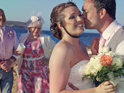The bride and groom having fun on the beach